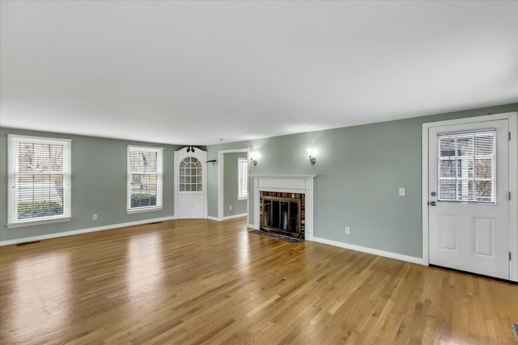 5 Dale Terrace Extension Sandwich, MA 02563 - Photo 4 of 31 an empty room with wooden floor fireplace and windows