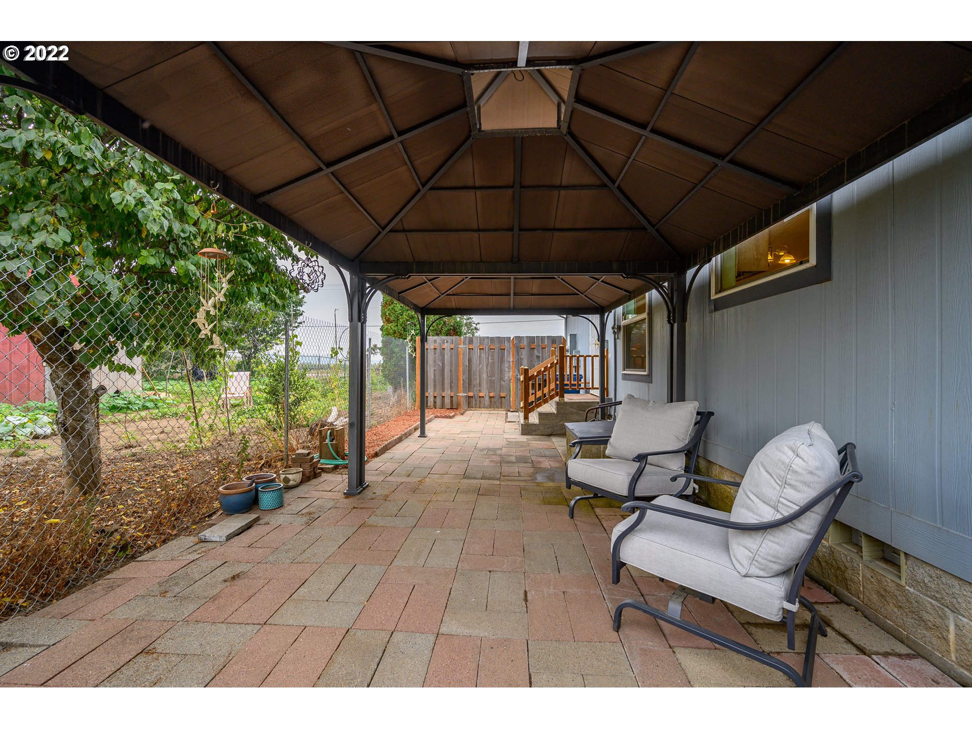 17600 Northeast Boones Ferry Road Northeast Hubbard, OR 97032 - Photo 19 of 28 a backyard of a house with table and chairs