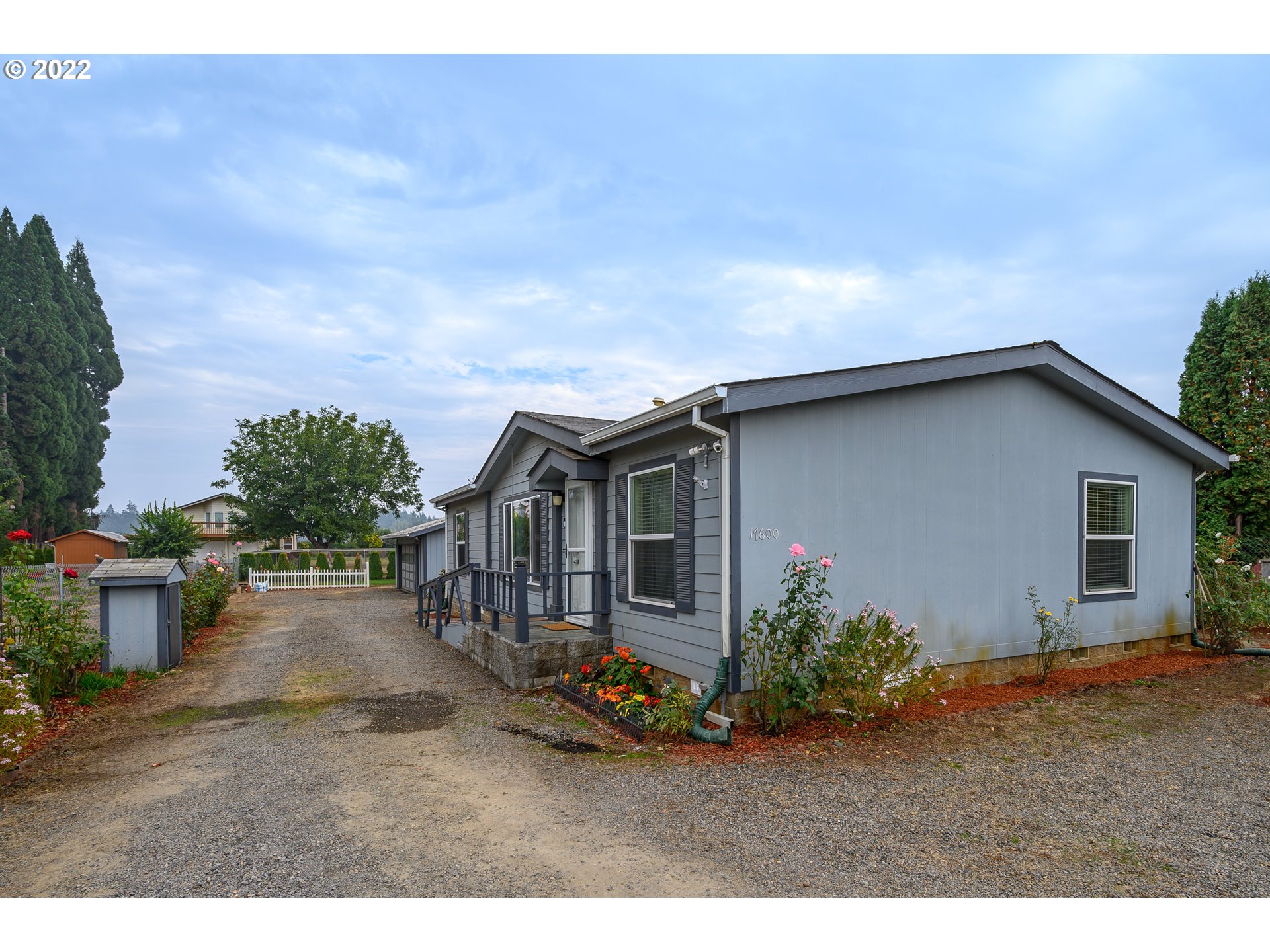 17600 Northeast Boones Ferry Road Northeast Hubbard, OR 97032 - Photo 2 of 28 a backyard of a house with dishwasher and wooden fence