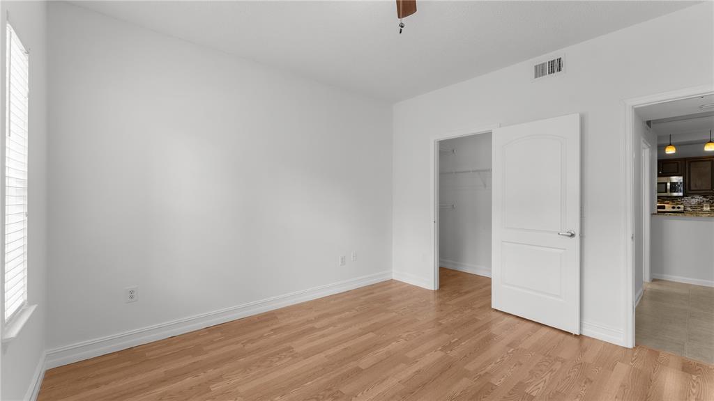 12204 Wild Iris Way, Unit 103 Orlando, FL 32837 - Photo 14 of 22 an empty room with wooden floor