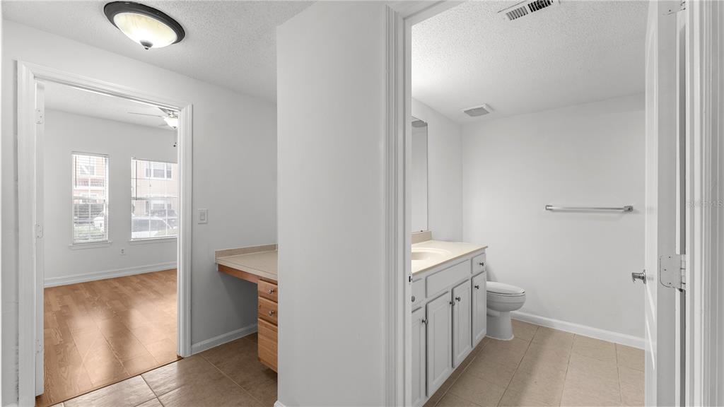 12204 Wild Iris Way, Unit 103 Orlando, FL 32837 - Photo 15 of 22 a bathroom with a sink and a mirror