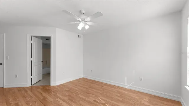 a view of a room with wooden floor and closet