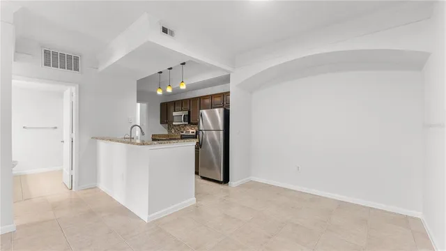 a view of kitchen and refrigerator