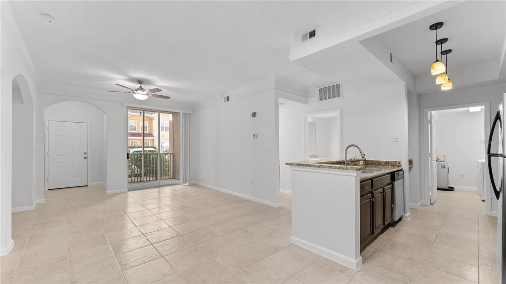 12204 Wild Iris Way, Unit 103 Orlando, FL 32837 - Photo 7 of 22 a kitchen with stainless steel appliances granite countertop a stove and a sink