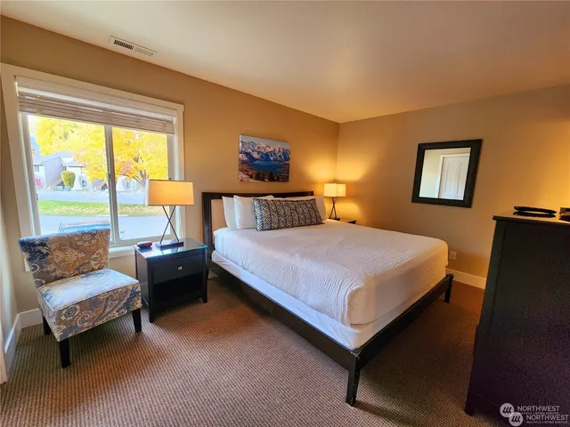 a bedroom with a bed and a couch