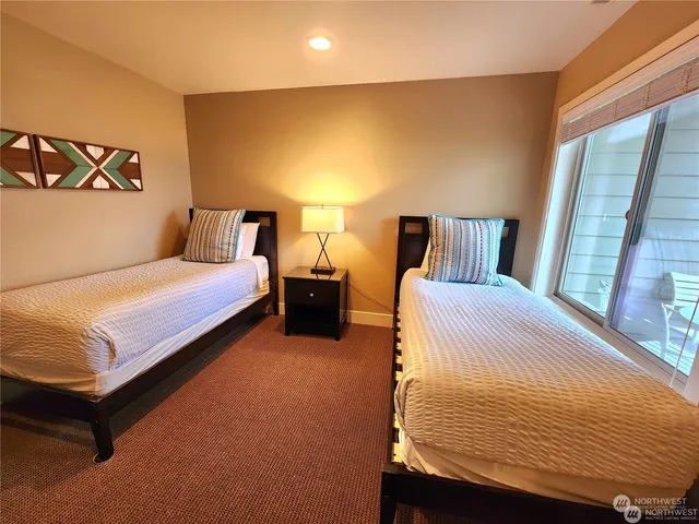 a bedroom with a bed and a night stand