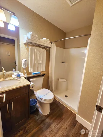 a bathroom with a sink toilet a mirror and shower