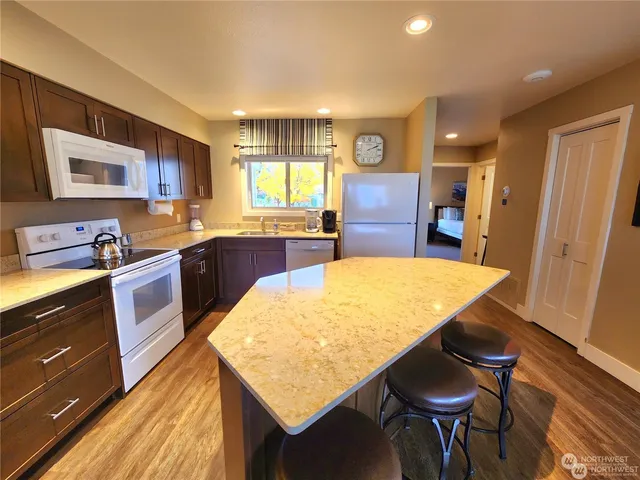 a kitchen with a table chairs sink and cabinets