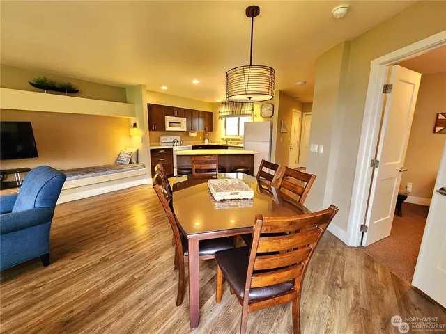 a view of a dining room with furniture wooden floor and chandelier