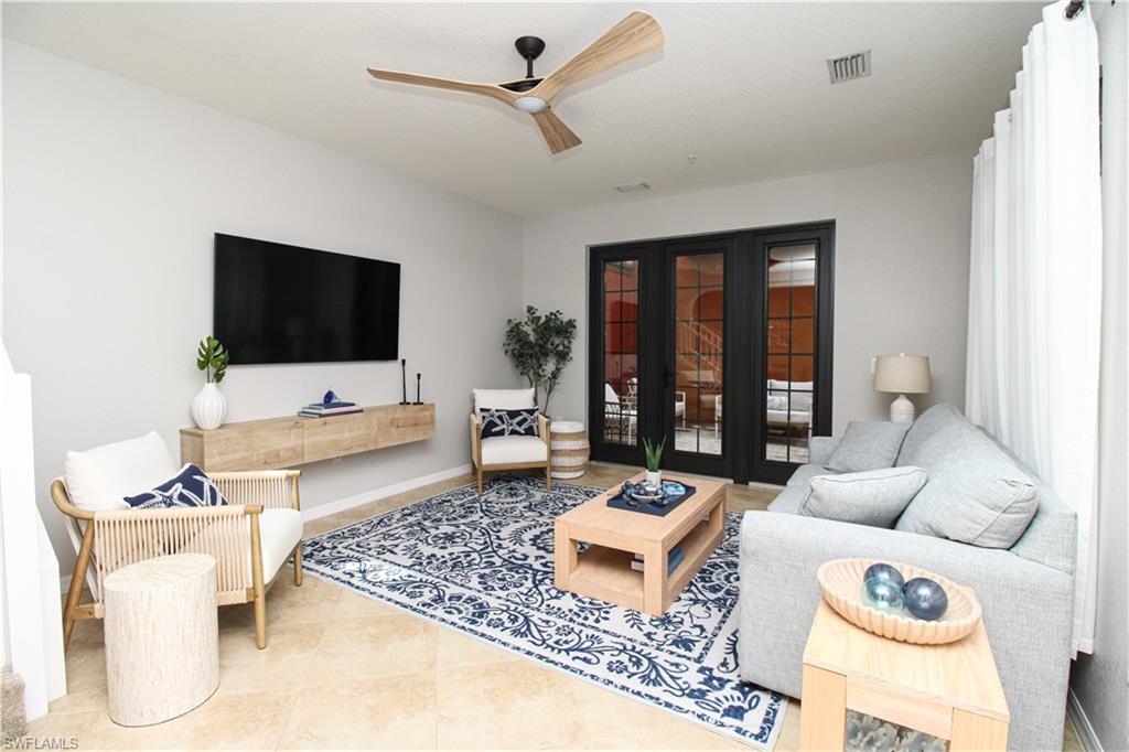 9025 Alturas Street, Unit 3102 Naples, FL 34113 - Photo 11 of 36 a living room with furniture and a flat screen tv