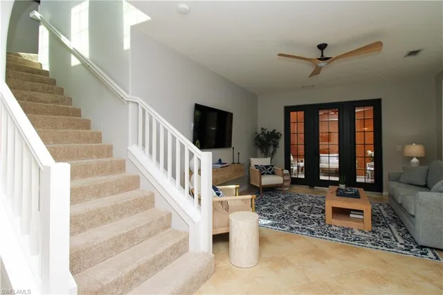 a living room with wooden floor and a flat screen tv
