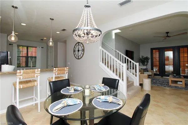 a view of a dining room with furniture wooden floor and chandelier