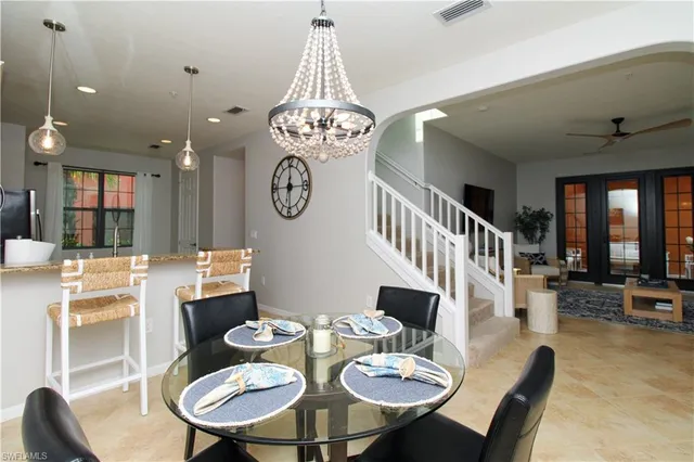 a view of a dining room with furniture wooden floor and chandelier