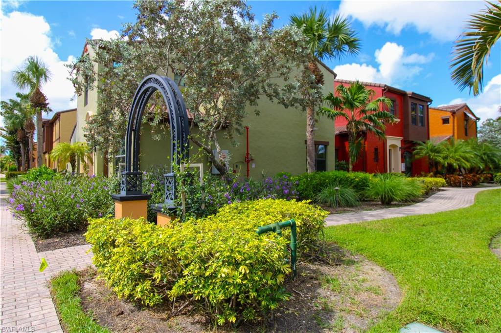9025 Alturas Street, Unit 3102 Naples, FL 34113 - Photo 2 of 36 a front view of a house with garden