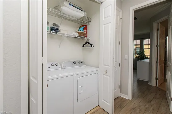 a view of walk in closet with clothes washer and dryer