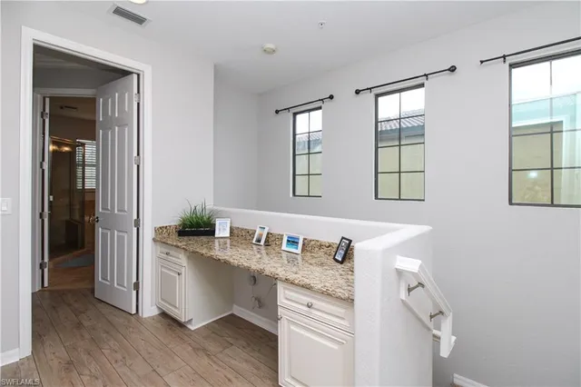 a bathroom with granite countertop a sink and a mirror