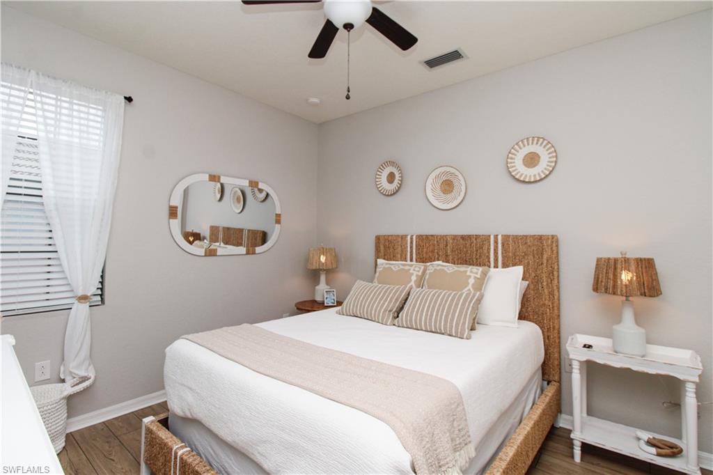 9025 Alturas Street, Unit 3102 Naples, FL 34113 - Photo 26 of 36 a bedroom with a bed and a lamp on the dresser