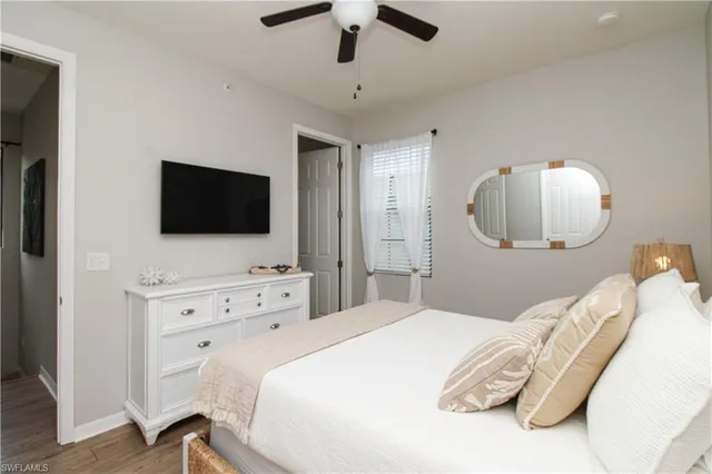 a bedroom with a bed tv and a chandelier