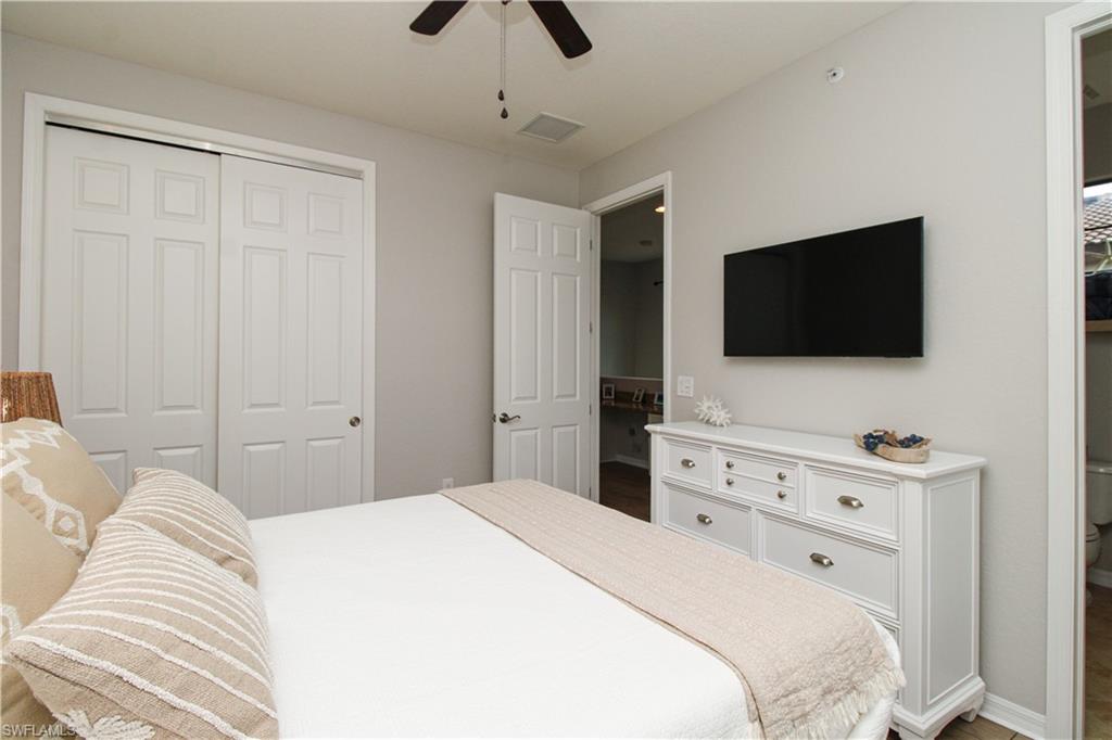 9025 Alturas Street, Unit 3102 Naples, FL 34113 - Photo 29 of 36 a bedroom with a bed and a flat screen tv