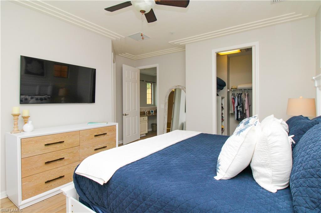 9025 Alturas Street, Unit 3102 Naples, FL 34113 - Photo 35 of 36 a bedroom with a bed and a flat screen tv
