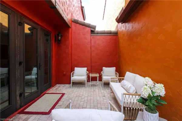 a couple of chairs sitting in patio of a house