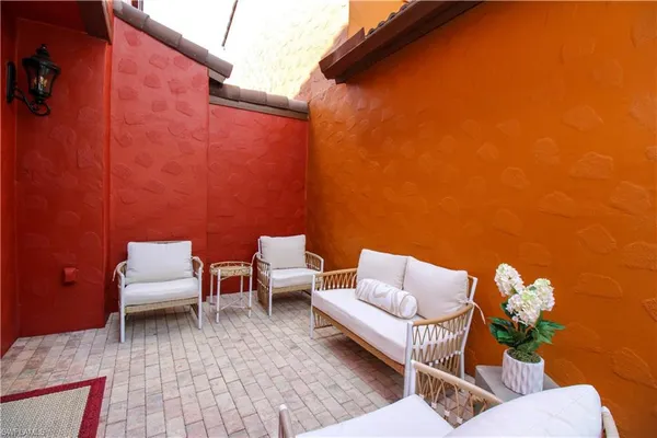 a backyard of a house with outdoor seating