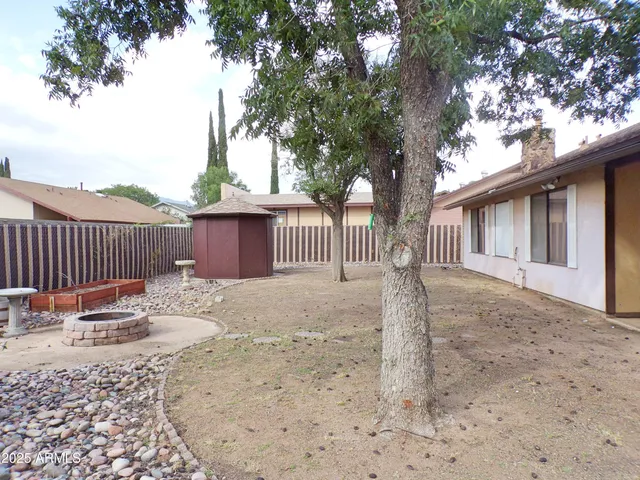 a backyard of a house with a tree