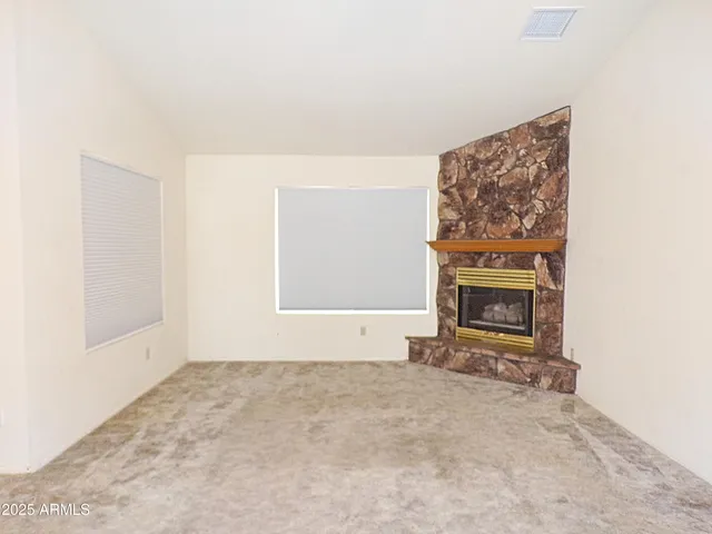 a view of empty room with a fireplace