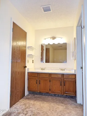 a bathroom with a double vanity sink and mirror