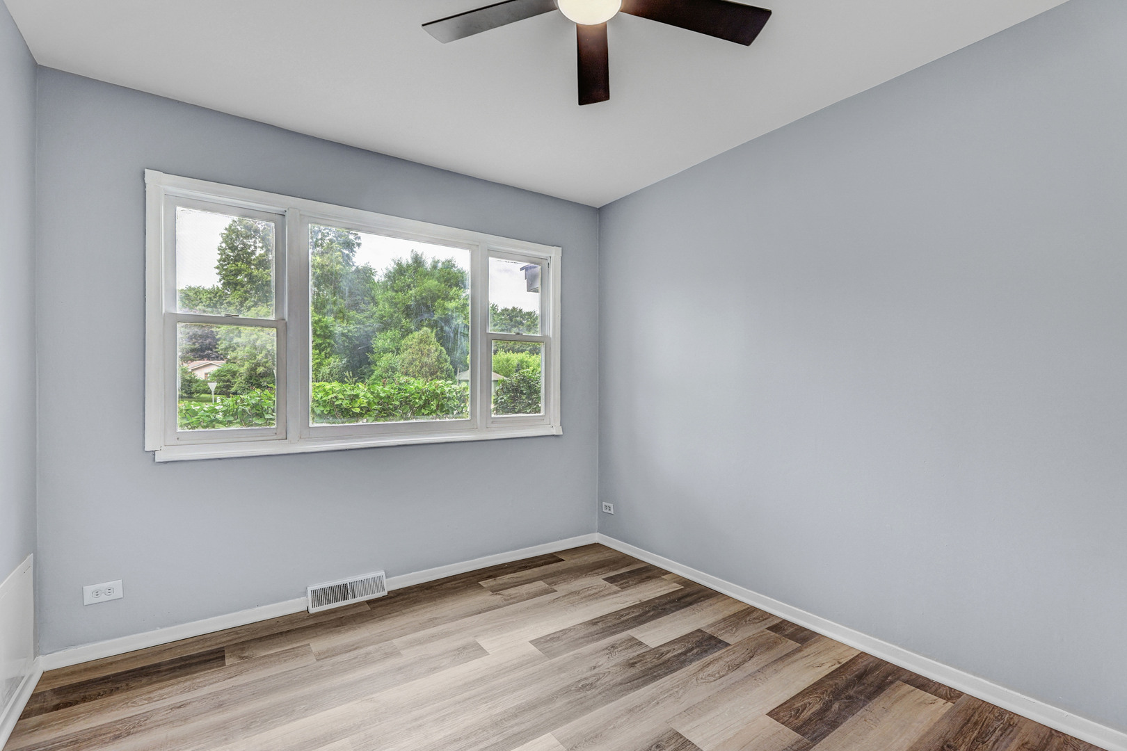 7001 Meadow Lane Road Long Grove, IL 60060 - Photo 17 of 48 a view of an empty room with wooden floor and a window