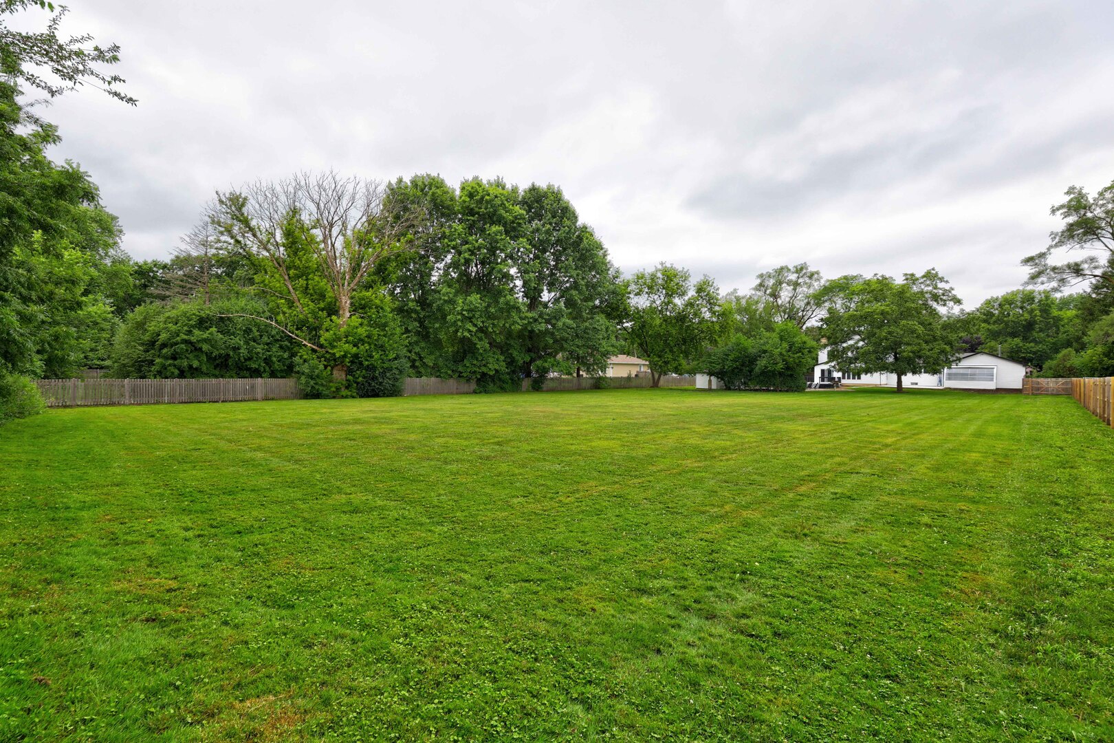 7001 Meadow Lane Road Long Grove, IL 60060 - Photo 3 of 48 a view of a green field with wooden fence