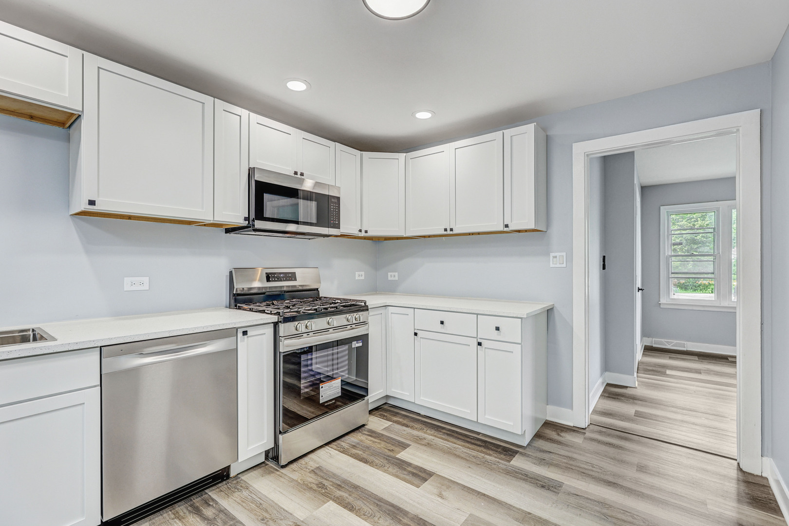 7001 Meadow Lane Road Long Grove, IL 60060 - Photo 4 of 48 a kitchen with stainless steel appliances granite countertop a stove a sink and a microwave
