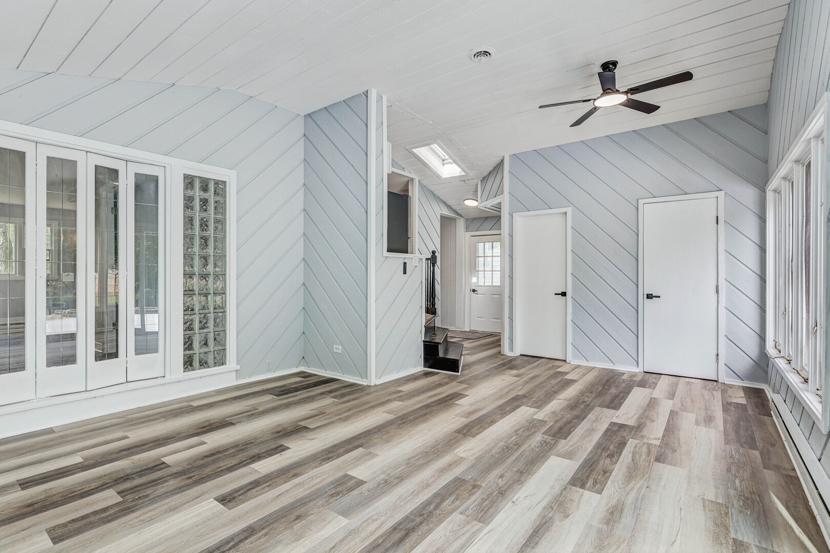 7001 Meadow Lane Road Long Grove, IL 60060 - Photo 6 of 48 a view of a livingroom with wooden floor and a ceiling fan
