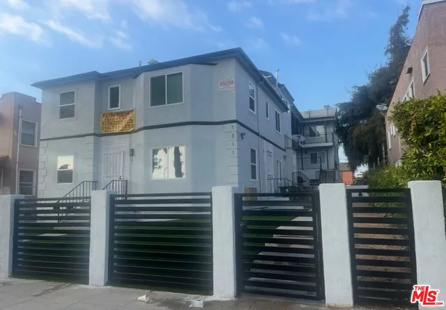 a view of a brick house with many windows