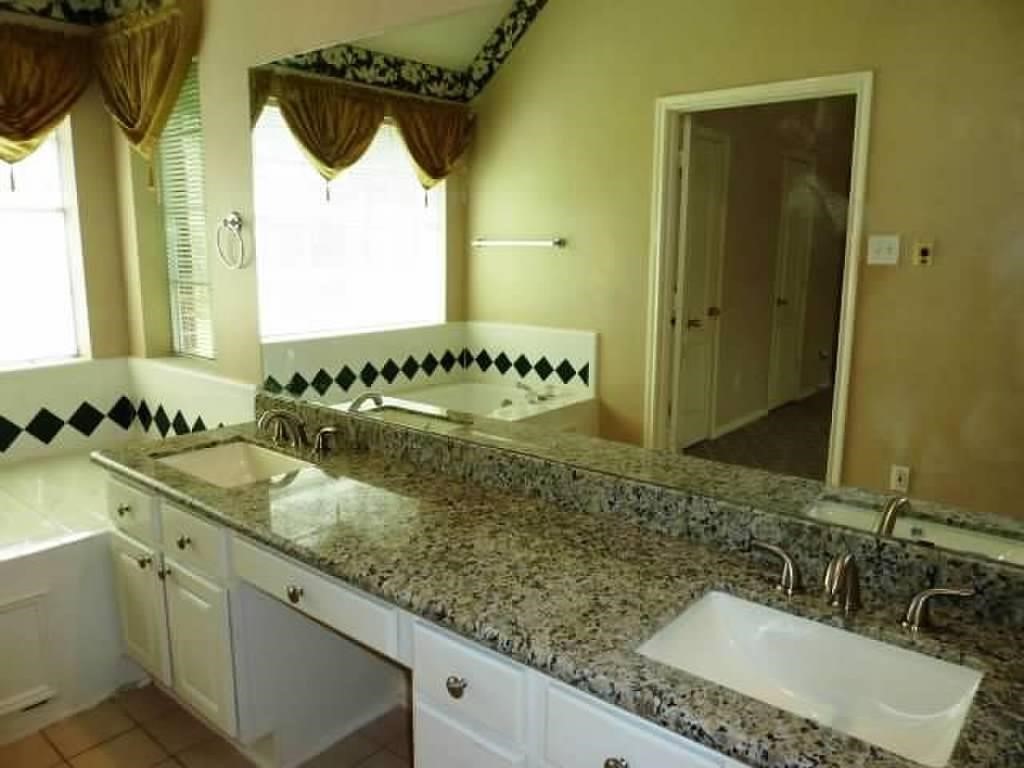 4542 Springfield Lakes Street Sugar Land, TX 77479 - Photo 11 of 16 Primary bathroom featuring dual vanities, ample storage, and elegant finishes.
