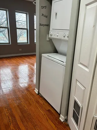 a view of washer and dryer with wooden floor