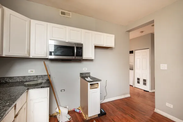 a kitchen with stainless steel appliances granite countertop a stove a microwave and a refrigerator