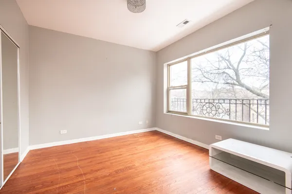 a big room with wooden floor and windows