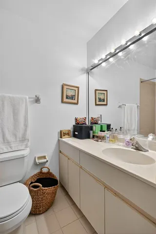 a bathroom with a sink a toilet and mirror