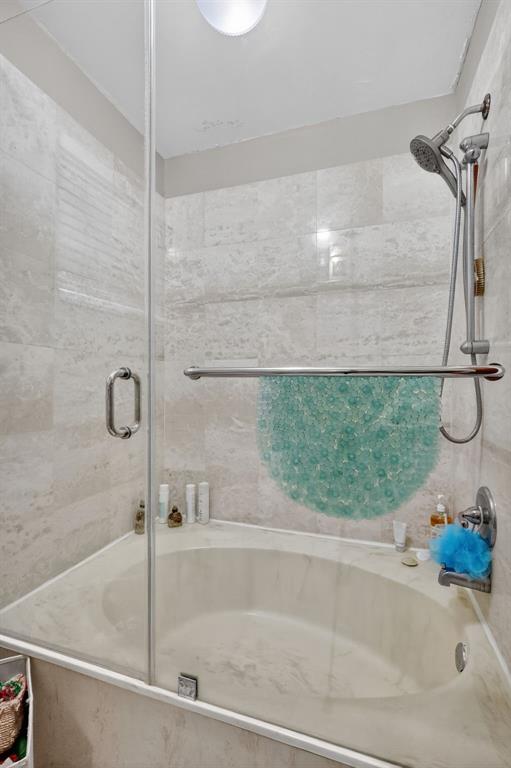 13501 Southwest 62nd Street, Unit 1 Miami, FL 33183 - Photo 17 of 38 a bathroom with a bathtub and a shower