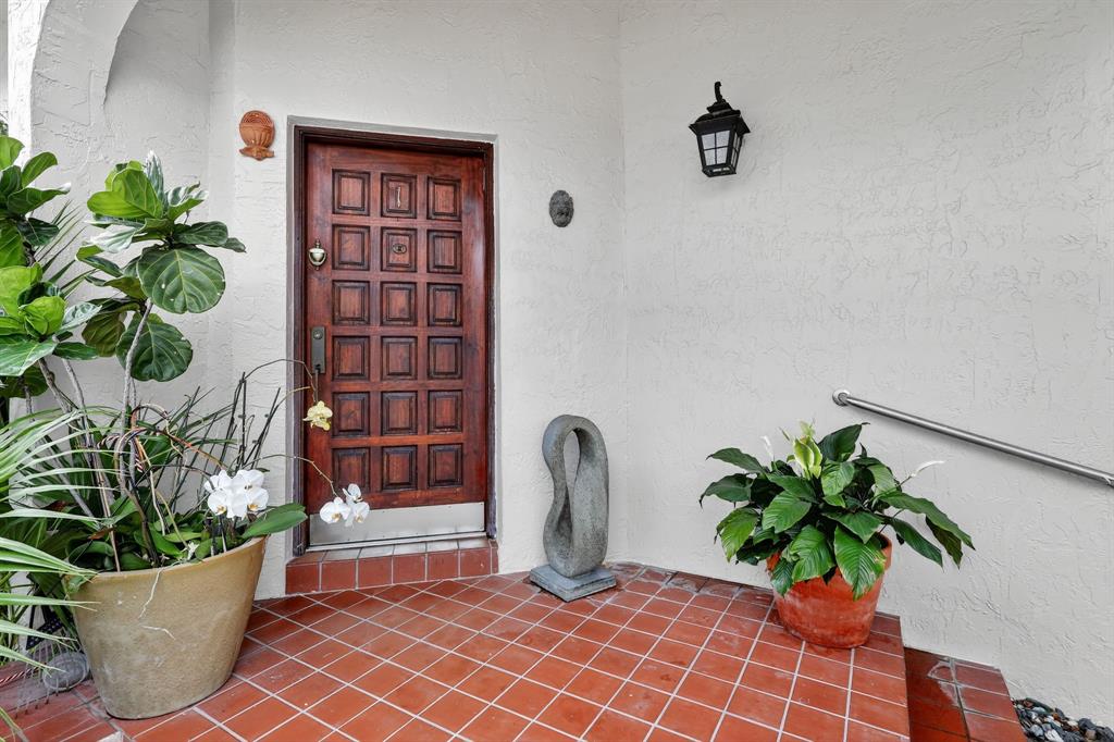 13501 Southwest 62nd Street, Unit 1 Miami, FL 33183 - Photo 2 of 38 a potted plant sitting on a floor in front of a door