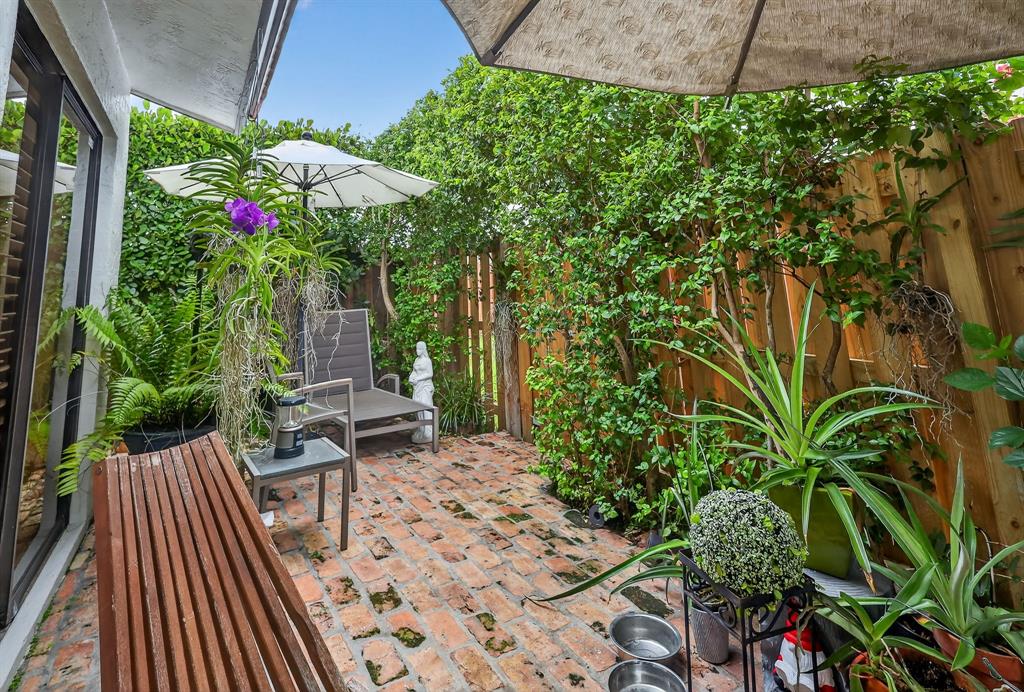 13501 Southwest 62nd Street, Unit 1 Miami, FL 33183 - Photo 24 of 38 a view of a chairs and table in a patio