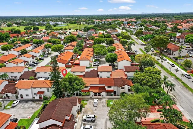 an aerial view of residential houses with outdoor space