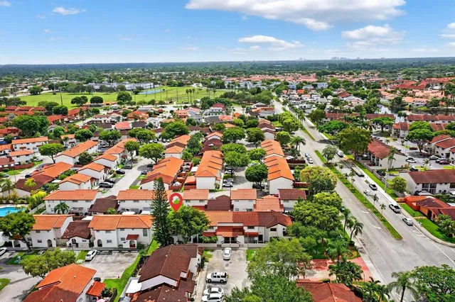 an aerial view of residential houses with outdoor space
