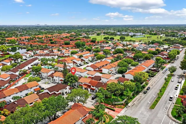 an aerial view of residential houses with outdoor space and street view
