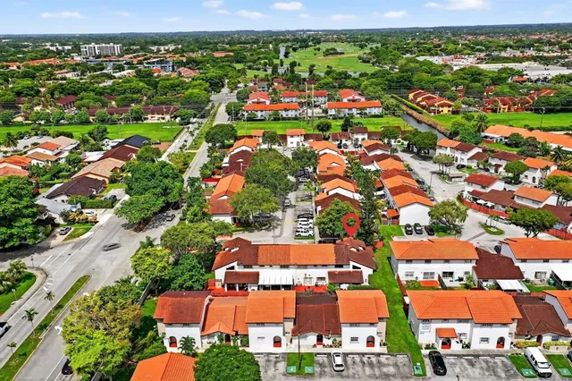 an aerial view of residential building and car parked
