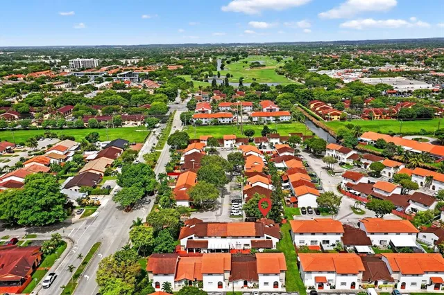an aerial view of residential houses with outdoor space