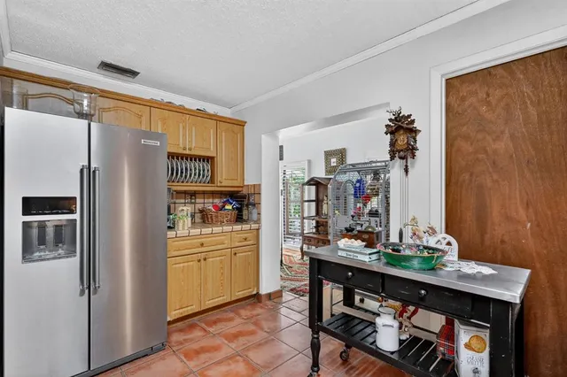 a kitchen with stainless steel appliances a refrigerator and a stove