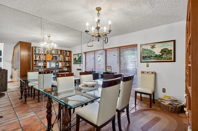 a view of a dining room with furniture wooden floor and chandelier