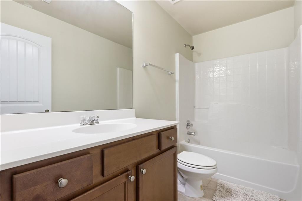 1515 Riva Ridge Suwanee, GA 30024 - Photo 25 of 35 a bathroom with a sink a toilet and shower